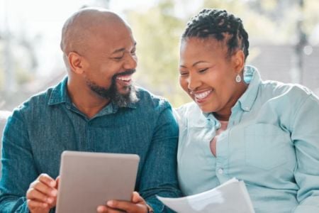 senior couple looking at a tablet