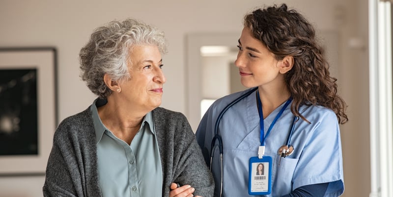 caretaker helping senior woman