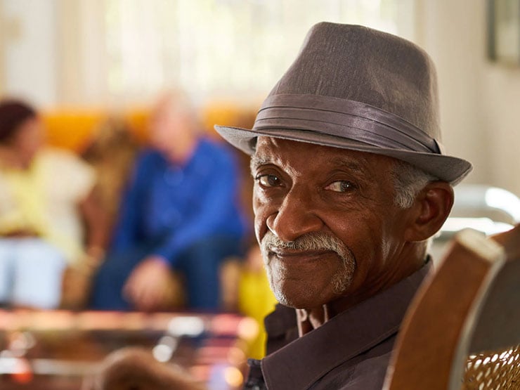 senior man looking at camera smiling