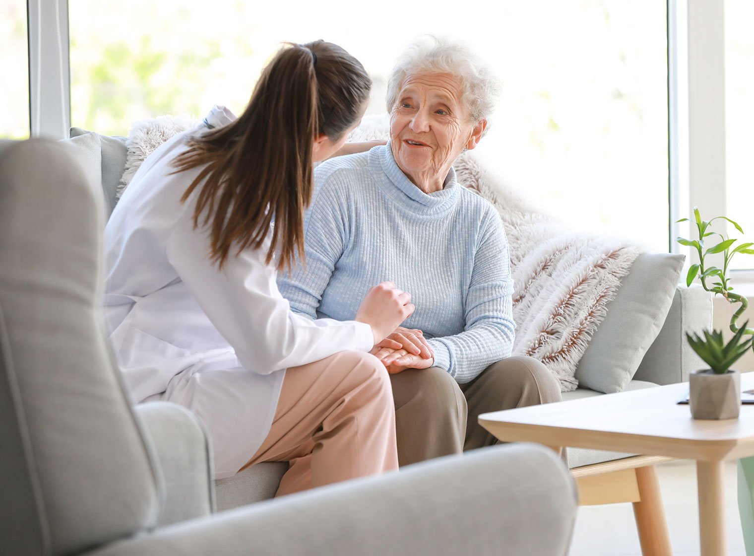 Doctor with senior woman in nursing home