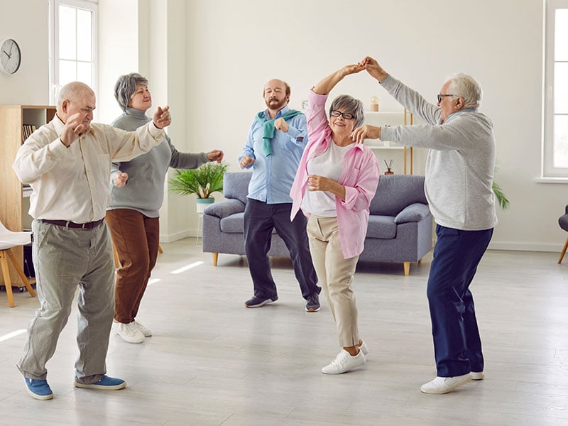 Full length portrait of a group of happy smiling senior people men and women having fun