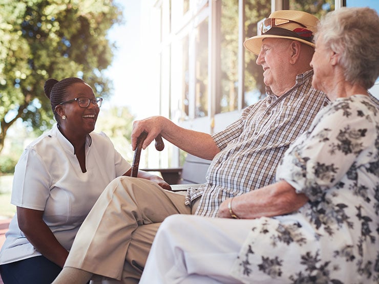 Senior couple talking to caregiver