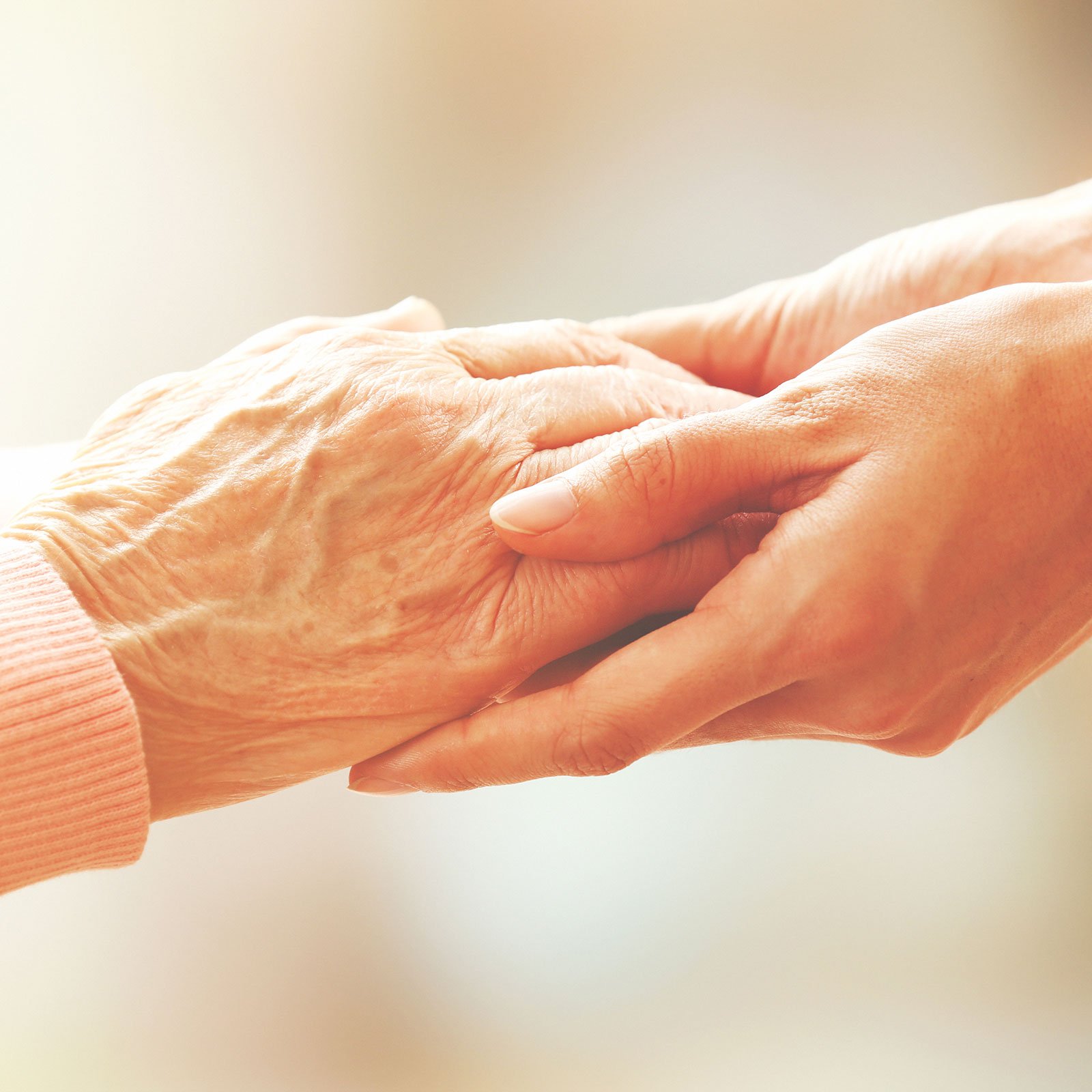Senior and caregiver hands