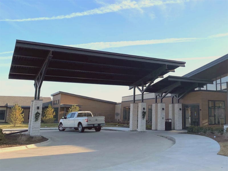 Senior community entrance with a covered driveway