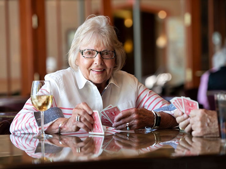 Senior woman playing cards