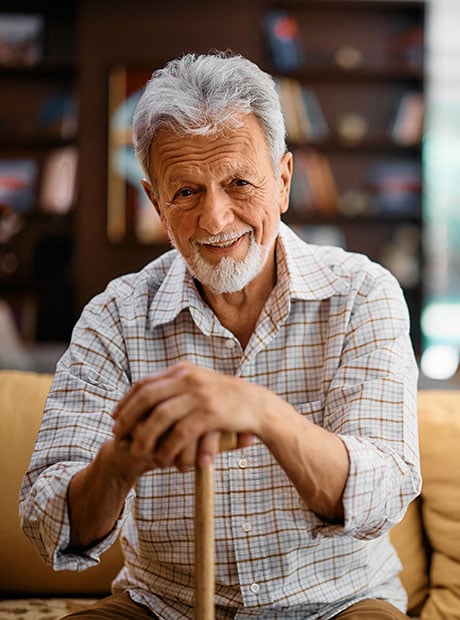 Smiling senior man at residential care home looking at camera