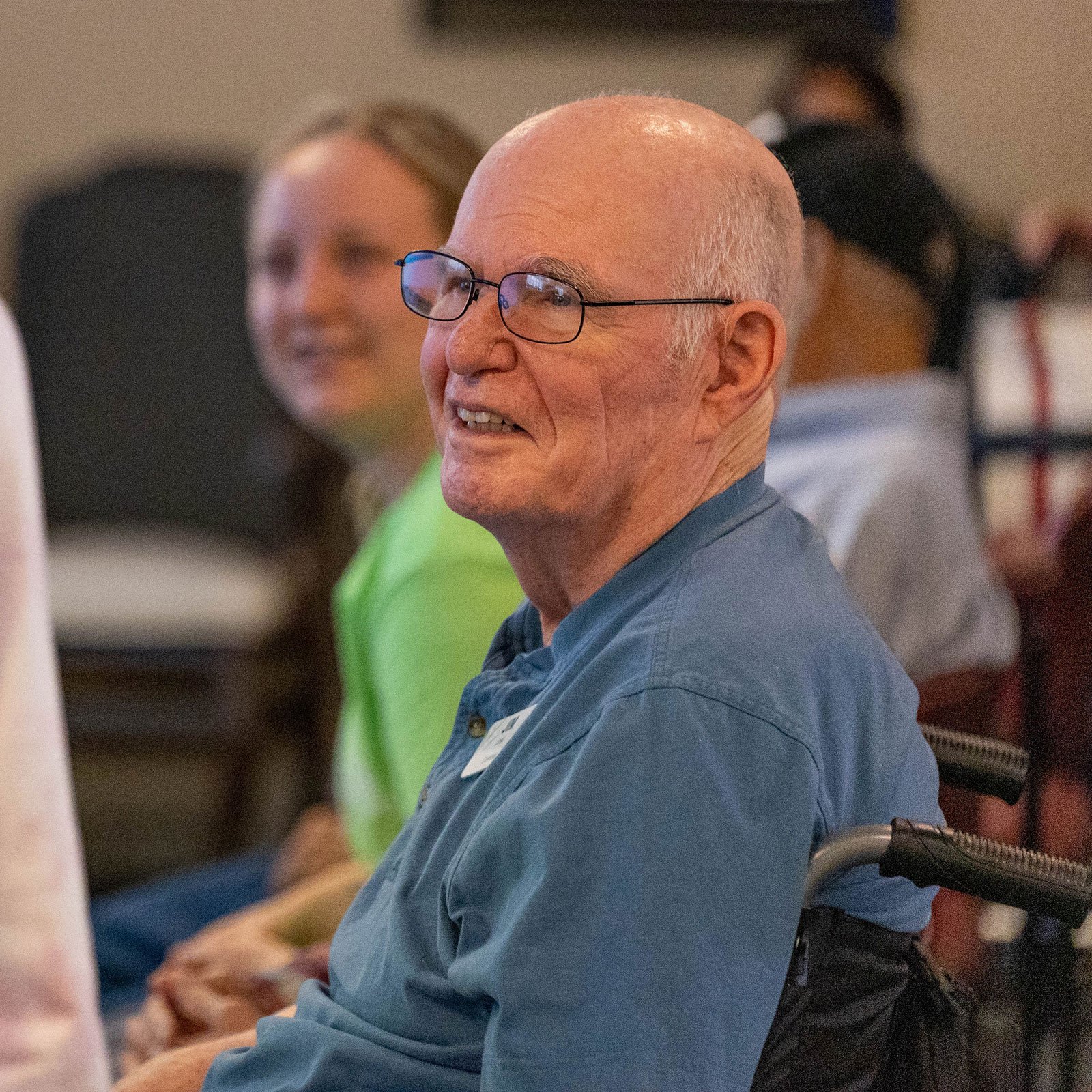 elderly man on a wheelchair smiling