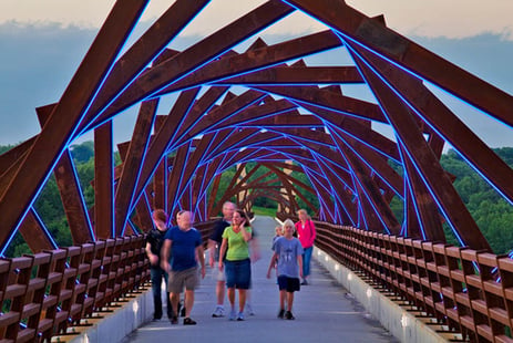 Group of people walking across a bridge