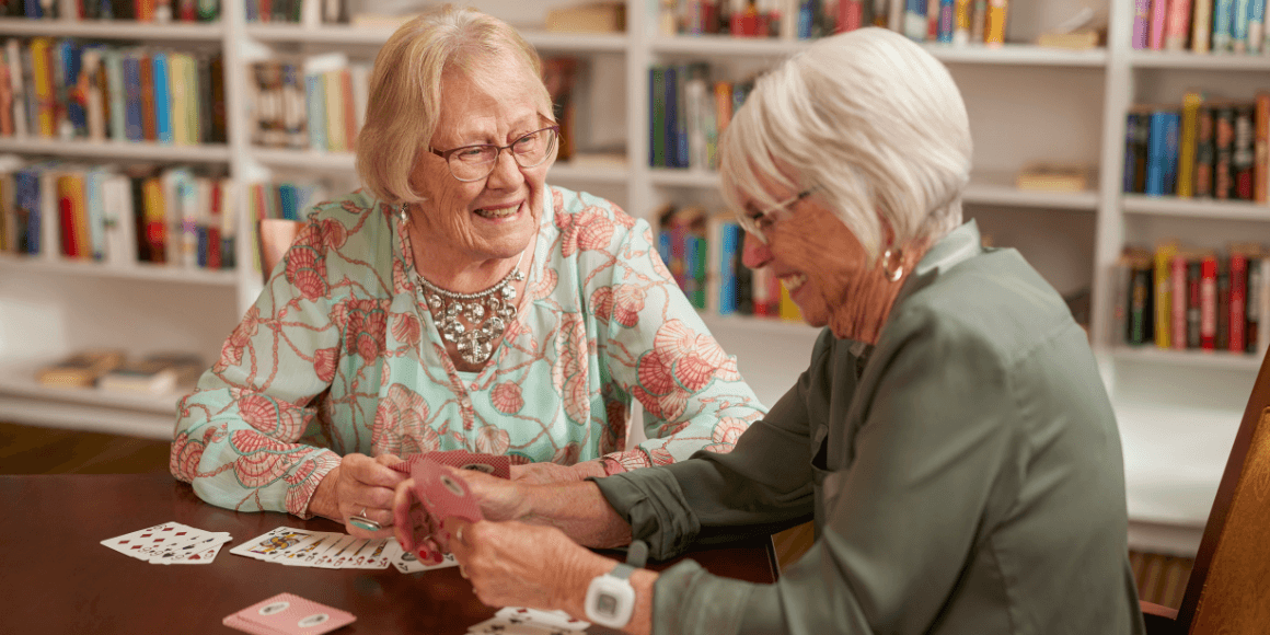 Two senior woman playing cards