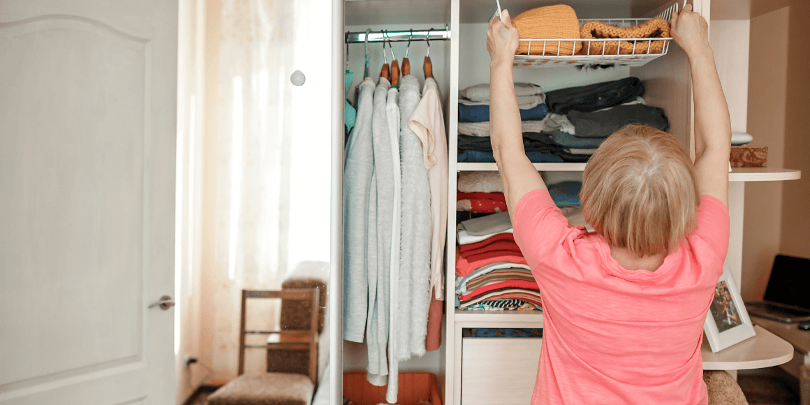 An older woman cleaning and organizing her closet