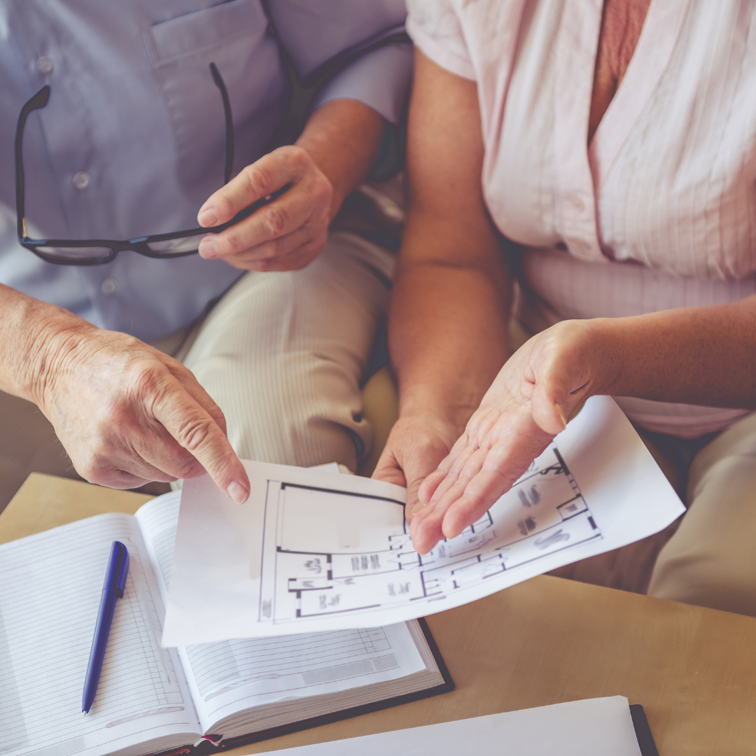 Woman and man looking at apartment floorplans
