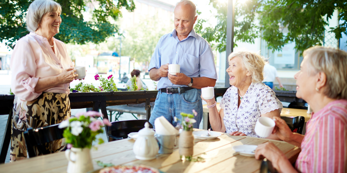 Group of people eating at a picnic table