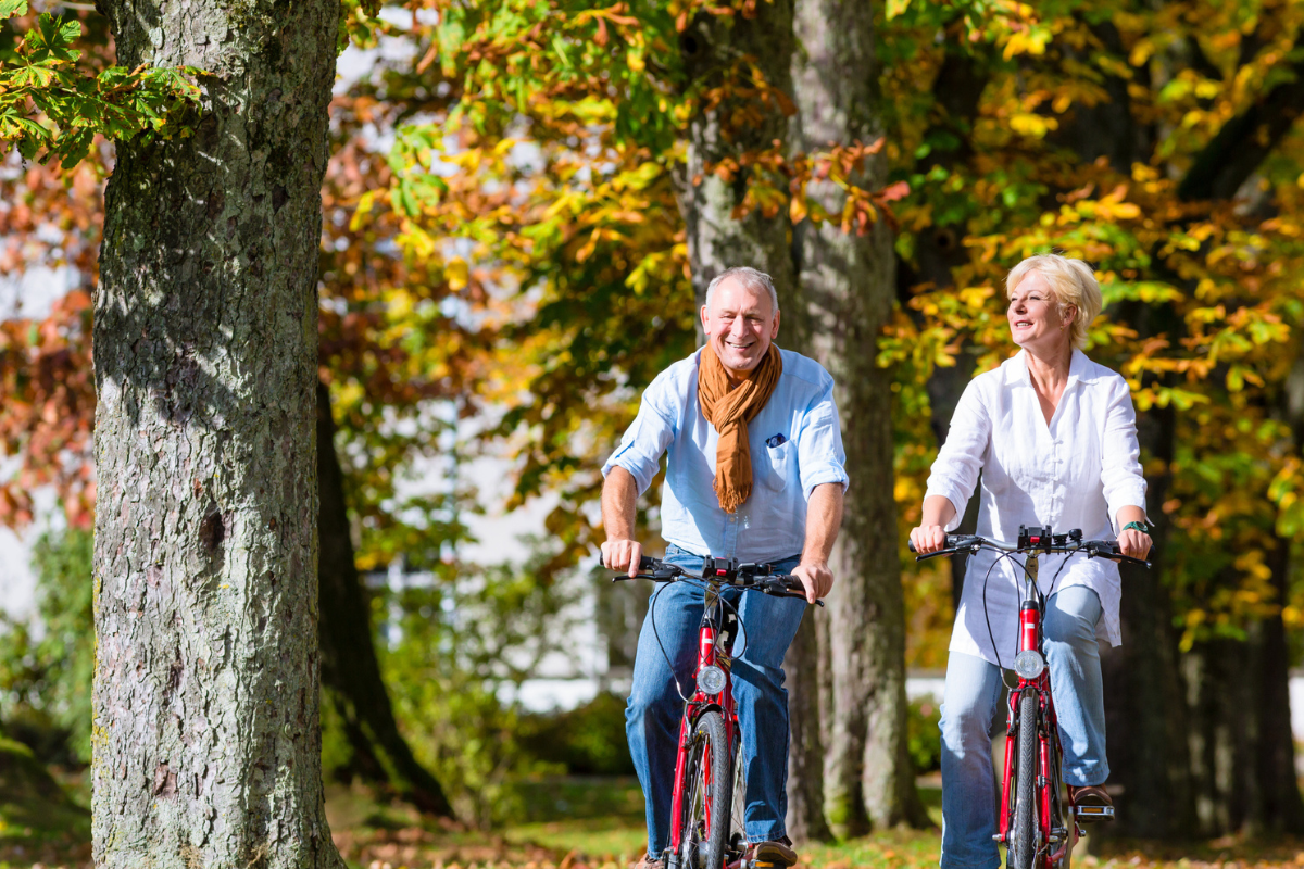Woman and man riding their bicycles outside
